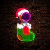 The cute Astronaut is sitting on the Christmas Sock Artwork Led Neon Sign - Reels Custom